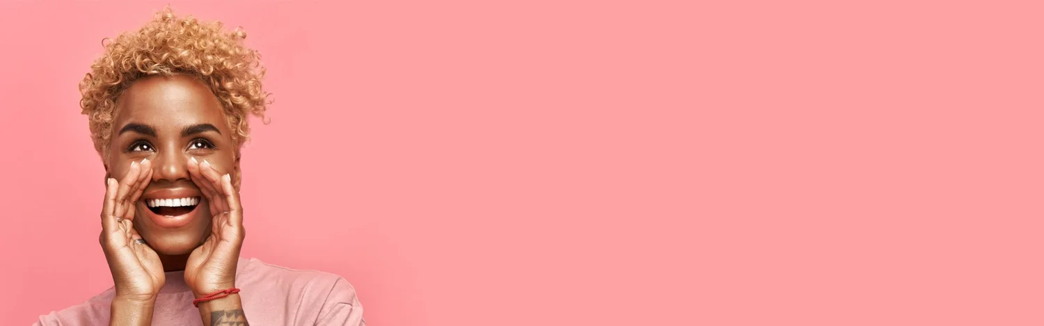 Smiling woman cupping her hands around her mouth as if calling out